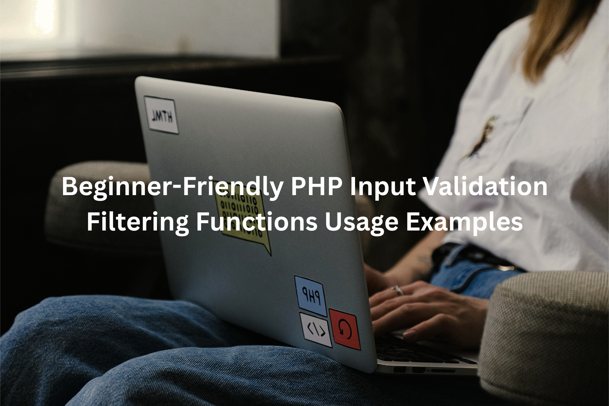 A person working on a laptop computer, with the laptop displaying HTML and PHP coding icons.